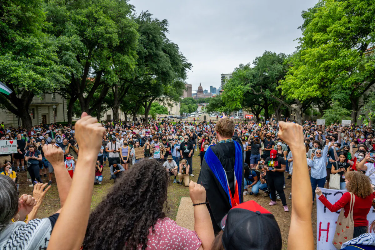 A professor speaks alongside gathered faculty on the South Lawn at the University of Texas at Austin in Austin, Texas, on May 5, 2024. During a rescheduled May Day rally, students and faculty gathered on the South Lawn to continue calling upon the university to fully divest from Israel. (Brandon Bell/Getty Images)
