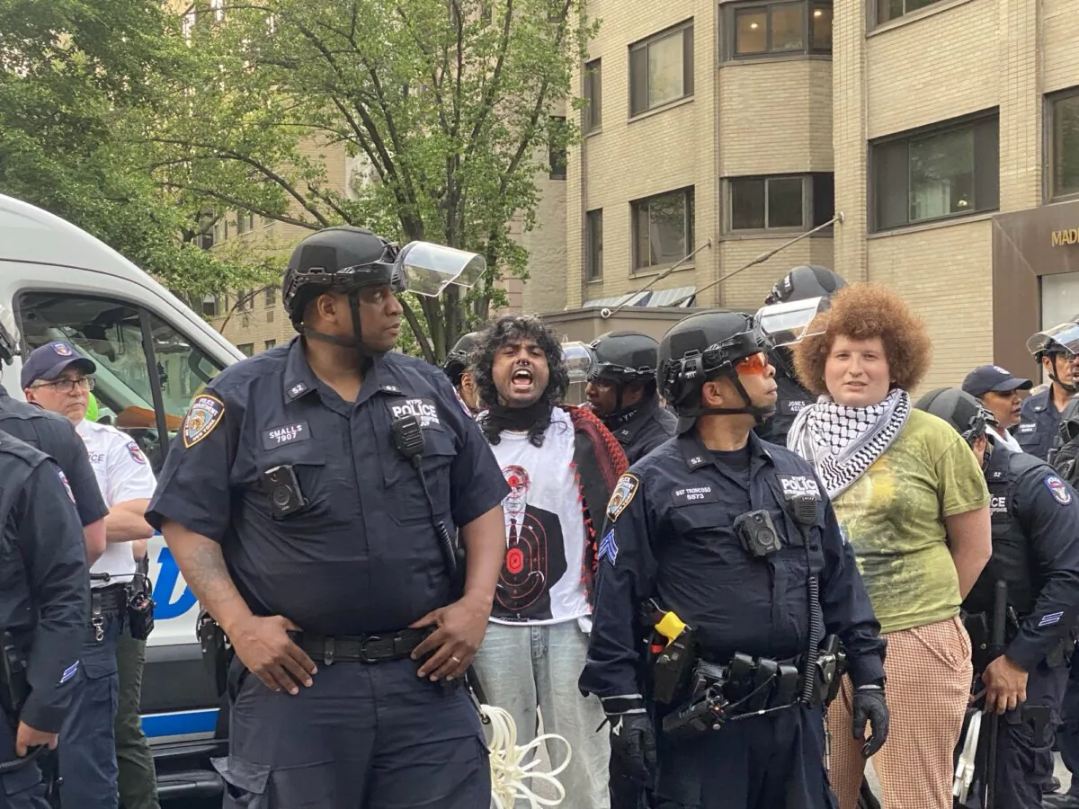 Police arrest protesters near the Met Gala in New York City on May 6, 2024. (Enrico Trigoso/The Epoch Times)
