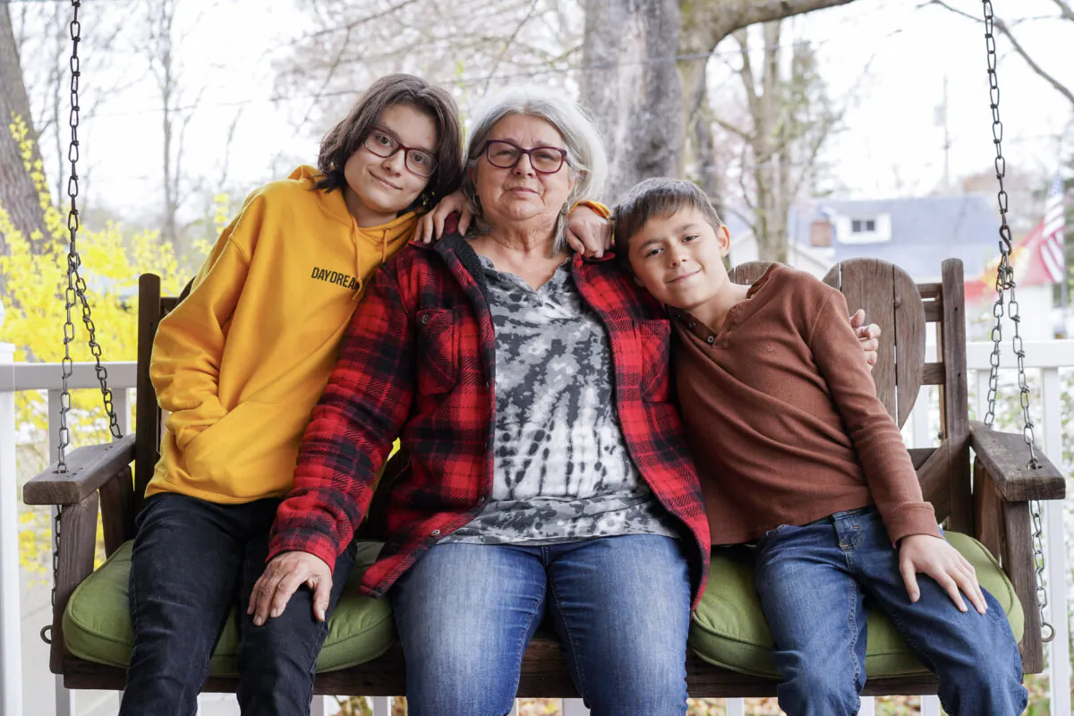 (L–R) Shania, Diana Mazza, and River on the porch of their house in the town of Deerpark, N.Y., on Apr. 18, 2024. (Cara Ding/The Epoch Times)