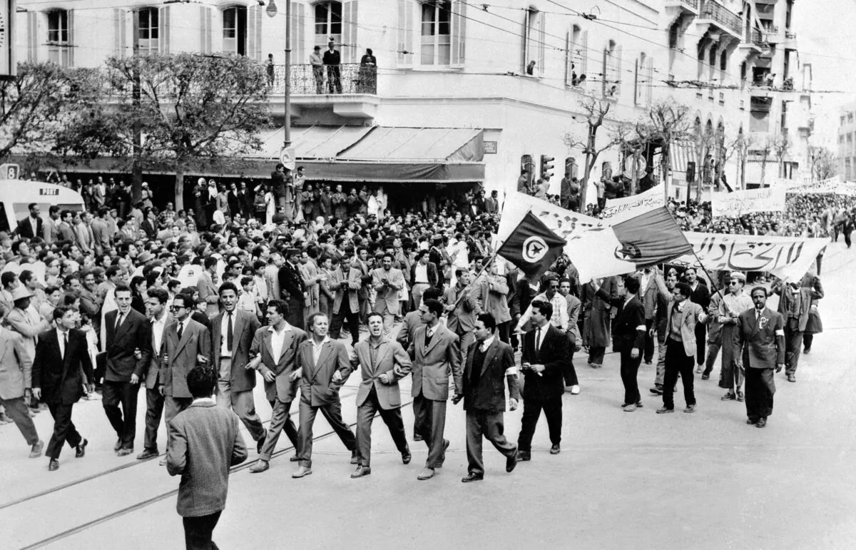 Demonstrators supporting Algerian independence from France parade through the streets of Tunis on May 1, 1956. Central among decolonization’s small coterie of founding theorists was Caribbean-French psychiatrist Frantz Fanon, writes Brock Eldon. (-/AFP via Getty Images)