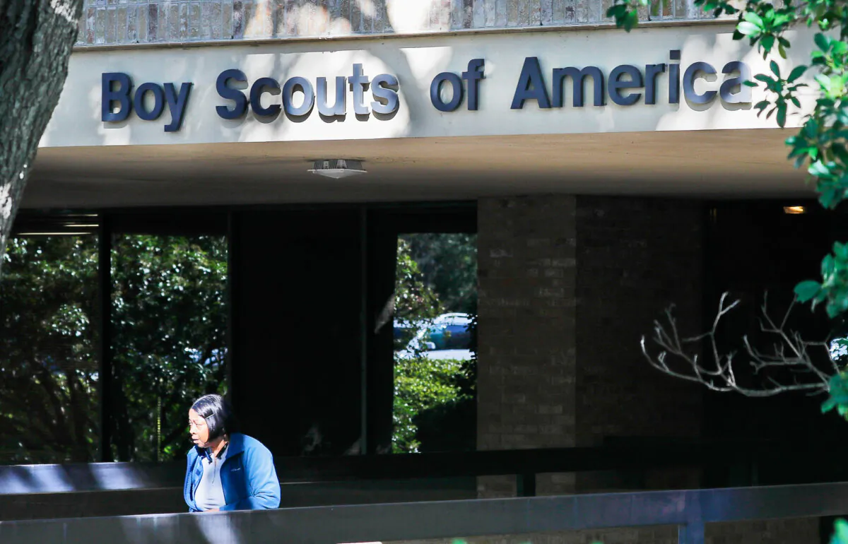 A woman walks out of the Boy Scouts of America national headquarters building in Irving, Texas, on Nov. 1, 2019. (AP Photo/LM Otero, File)