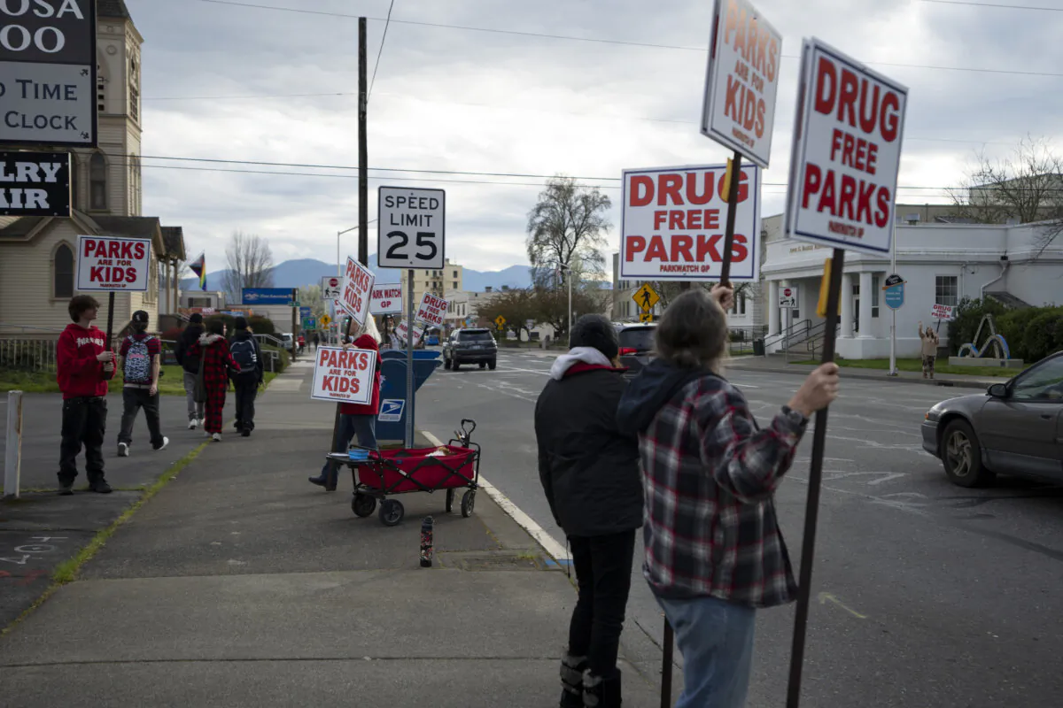 People protest against open drug use in parks outside City Hall in Grants Pass, Ore., on March 20, 2024. (AP Photo/Jenny Kane)