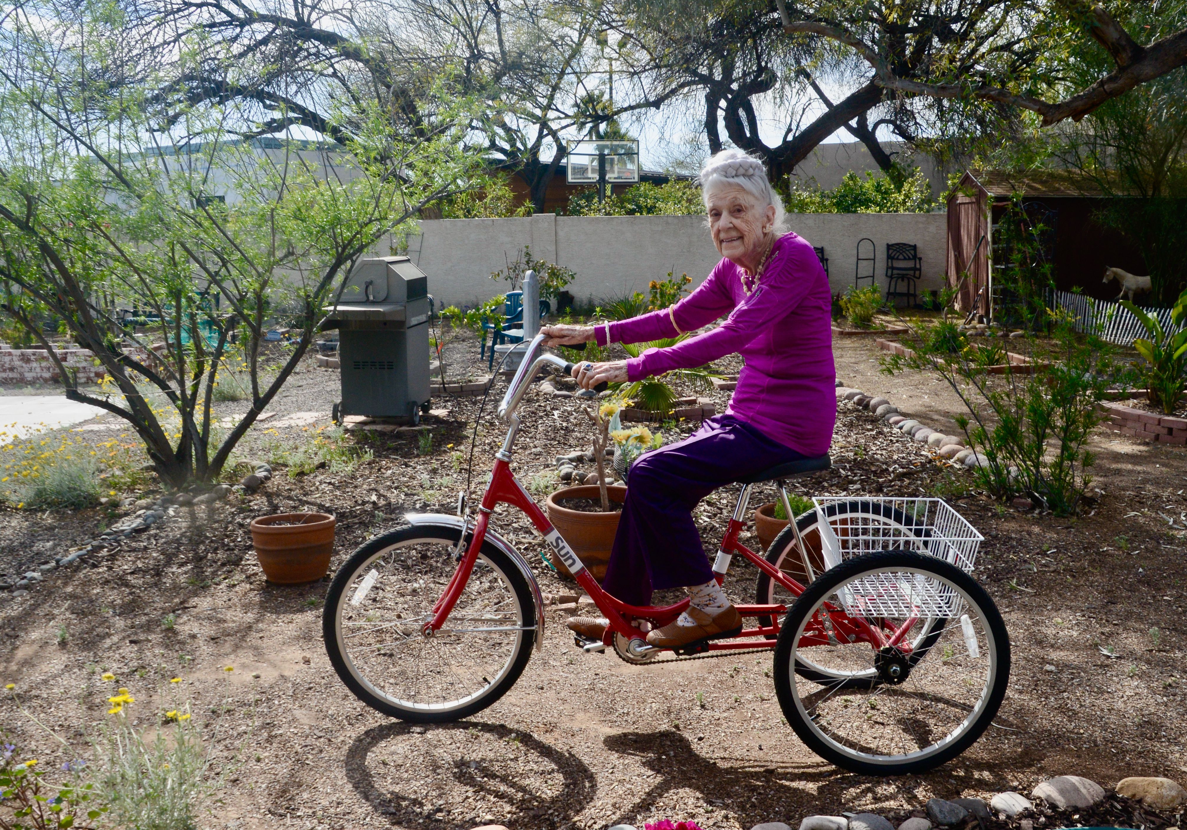 Mrs. McGarey riding a tricycle.