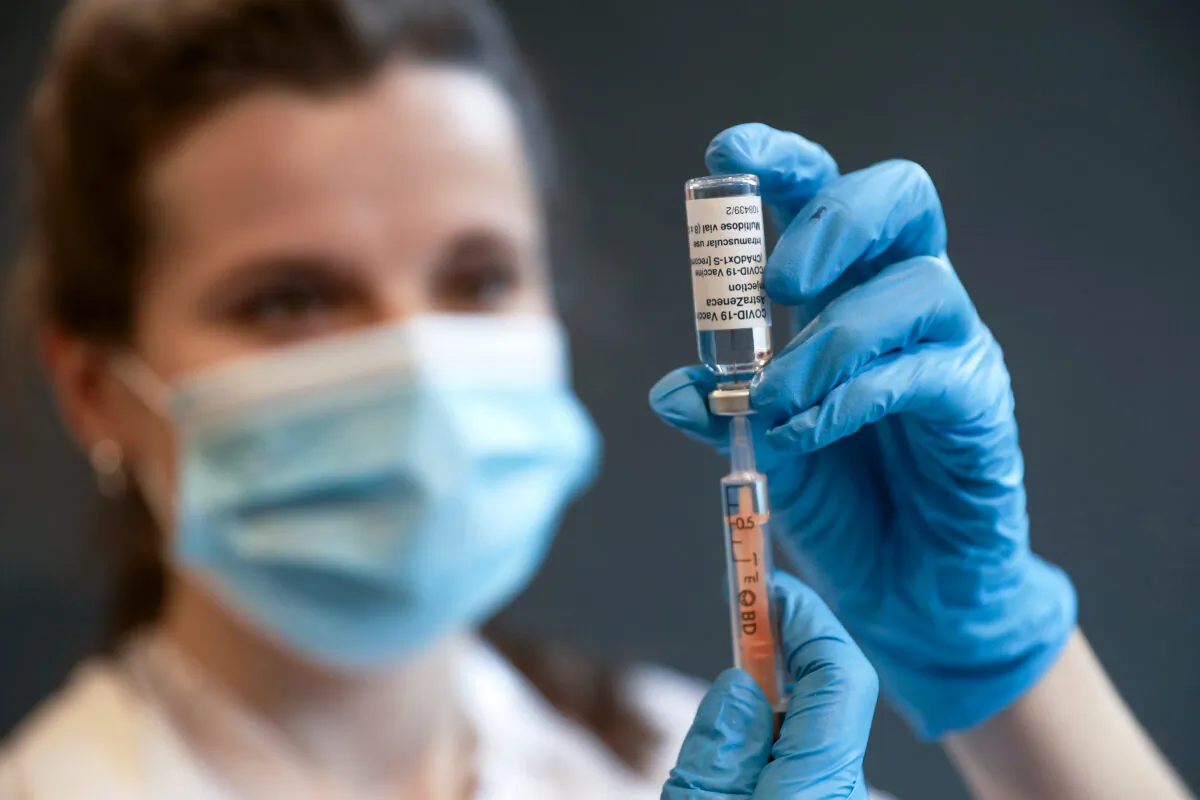 Clinical pharmacist Ellie Morton prepares to administer the Oxford AstraZeneca COVID-19 vaccine at the community vaccination centre at Kingston University's Penrhyn Road campus in London, England, on March 12, 2021. (Chris Jackson/Getty Images)