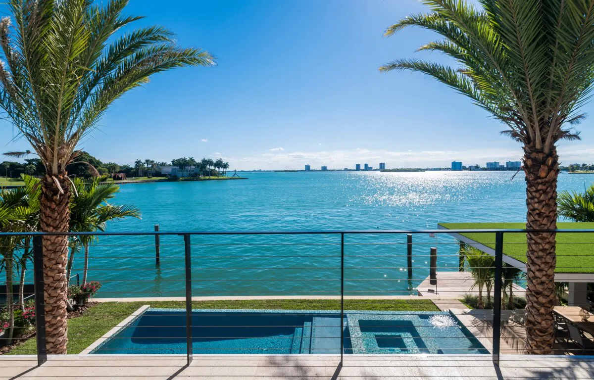 Miami Beach - April 2019: View of a nice pool and waterfront from terrace of a luxury home. (MDV Edwards/Shutterstock)