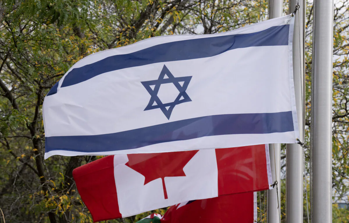 Canadian and Israeli flags fly in Ottawa on Oct. 11, 2023. (The Canadian Press/Adrian Wyld)