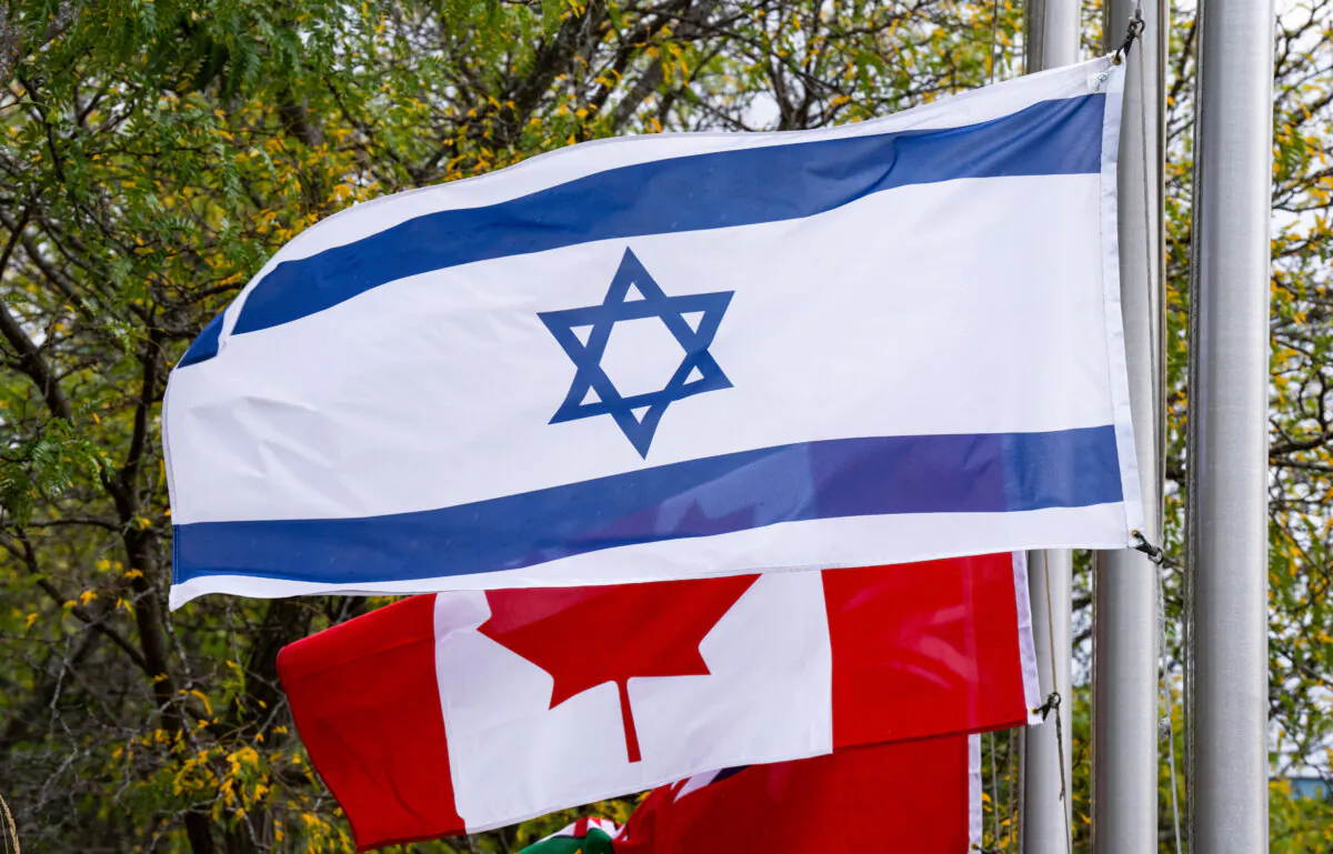 Canadian and Israeli flags fly in Ottawa on Oct. 11, 2023. (The Canadian Press/Adrian Wyld)