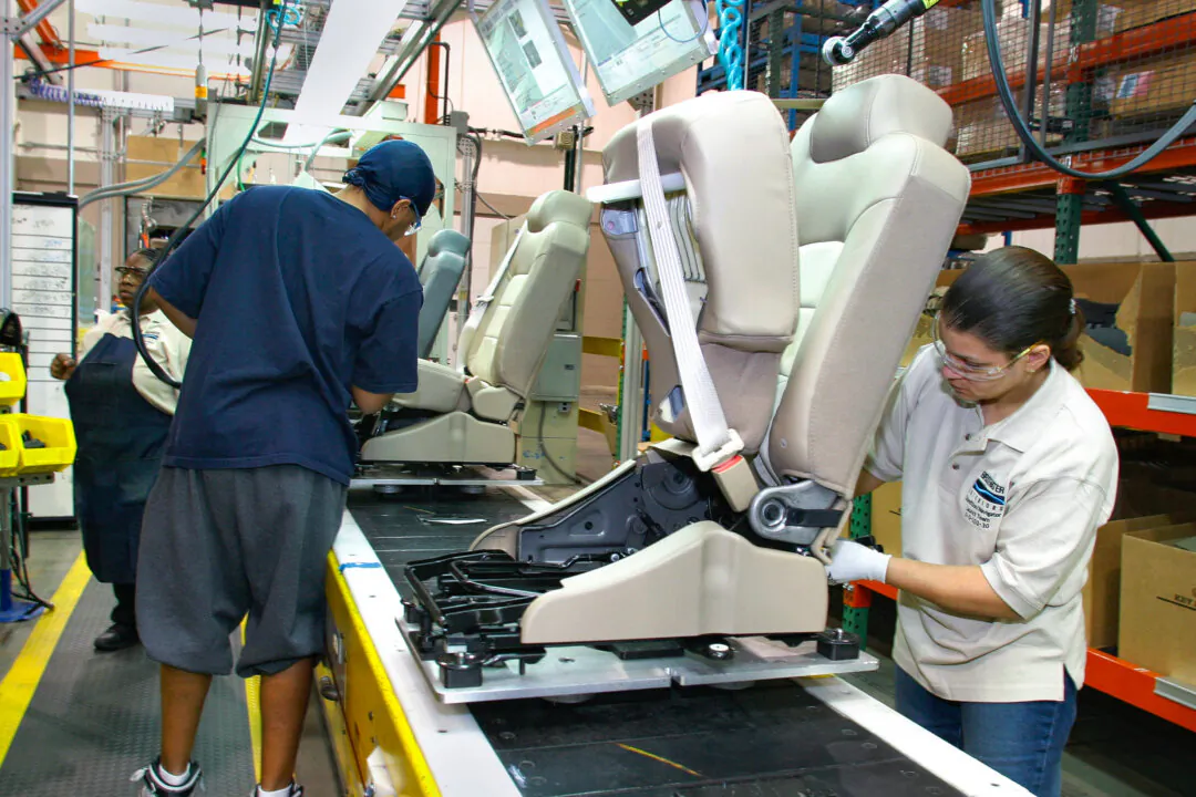 Production workers assemble car seats at the Bridgewater Interiors manufacturing plant in Warren, Mich., on March 8, 2004. (Bill Pugliano/Getty Images)

