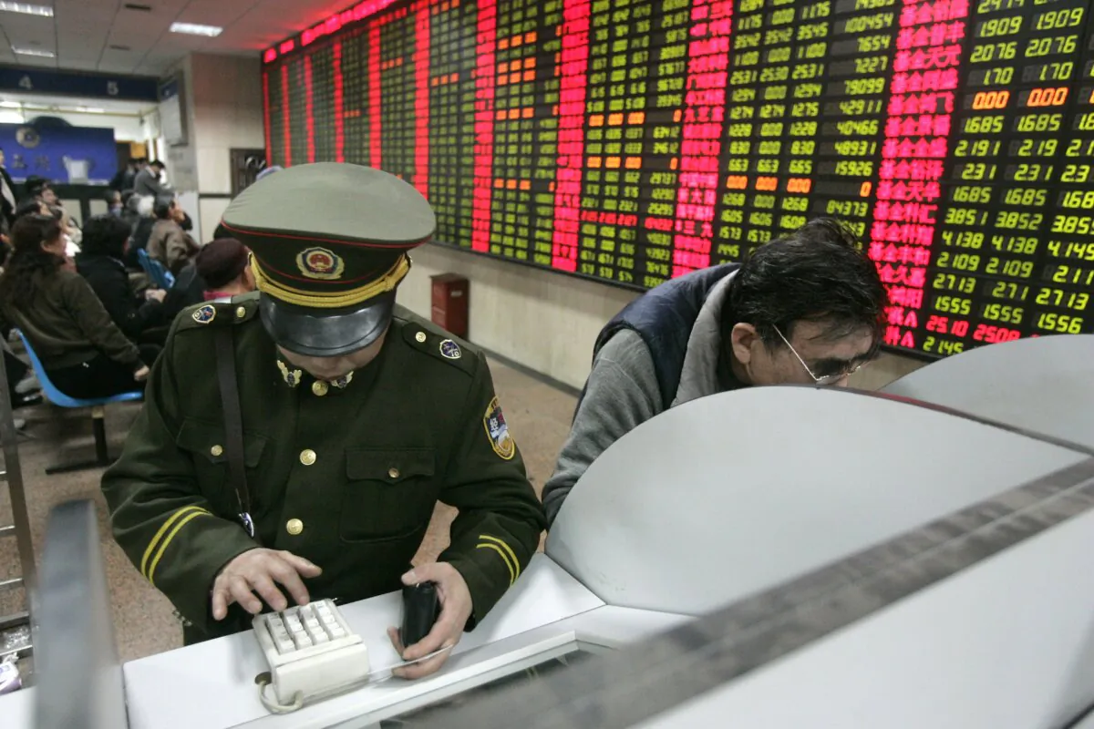 An economic policeman operates stock trading at a securities company on March 18, 2008 in Shanghai, China. (China Photos/Getty Images)