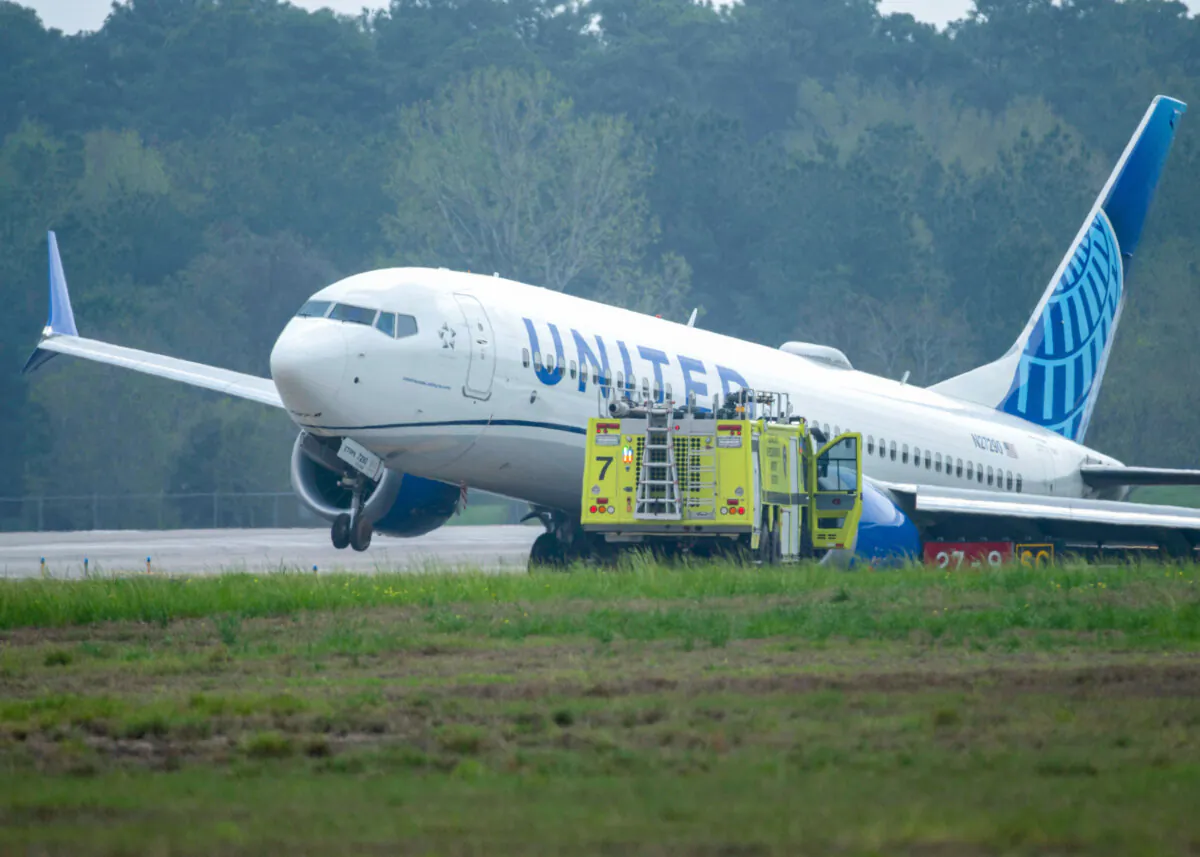 A United Airlines jet sits in a grassy area after leaving the taxiway at George Bush Intercontinental Airport in Houston on March 8, 2024. (Jason Fochtman/Houston Chronicle via AP)