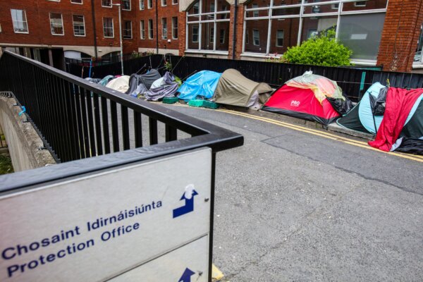 A photograph taken on June 12, 2023 shows a makeshift refugee and migrant camp outside the Irish Governments International Protection Office, in Dublin city centre. The makeshift camp provokes tension amongst asylum seekers and residents, with one such camp attacked nearby and tents burned. On top of the 70,000 thousand Ukrainians fleeing the war over 13,000 asylum seekers have arrive in Ireland over the last year, leaving many to survive on the street. (Photo by PAUL FAITH / AFP) (Photo by PAUL FAITH/AFP via Getty Images)