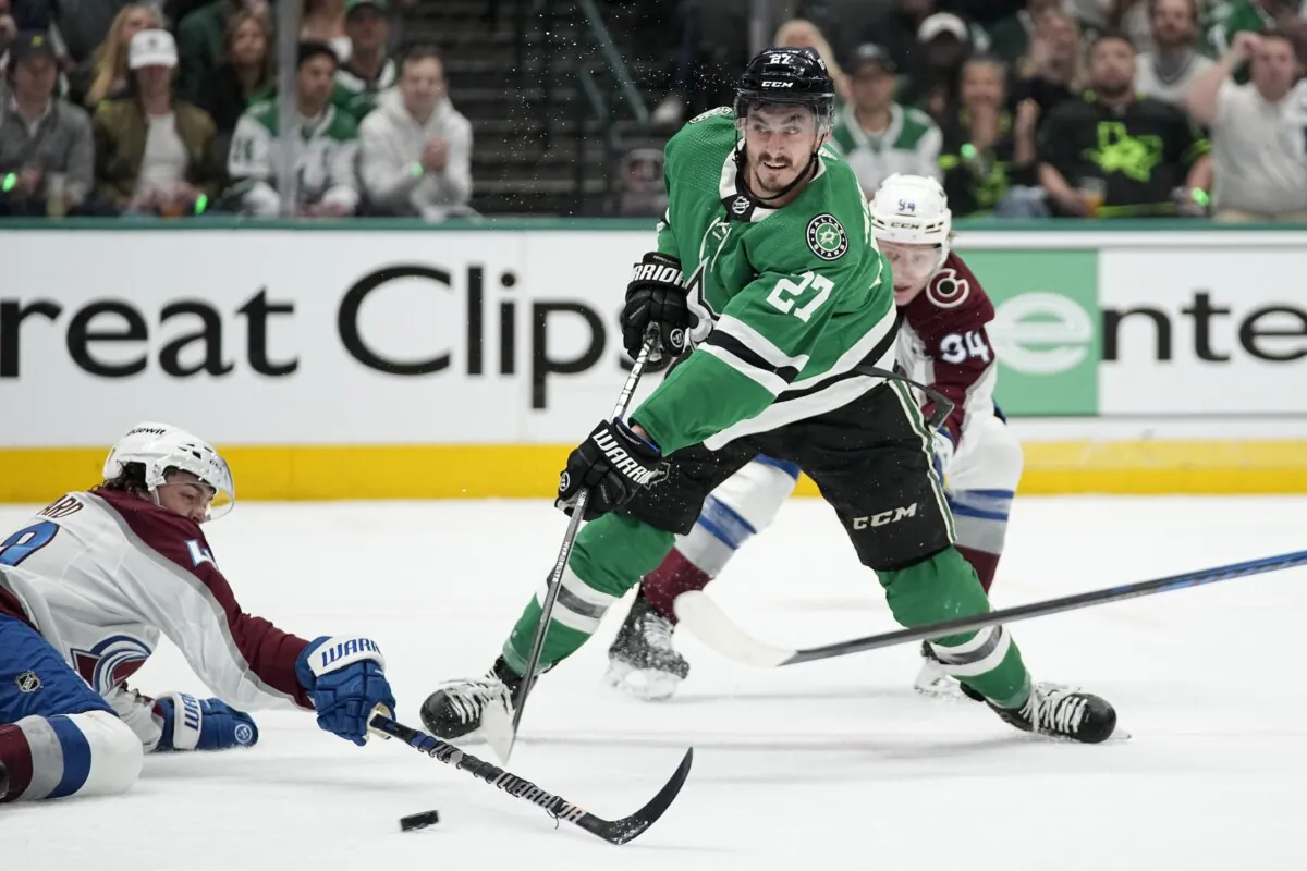 Dallas Stars left wing Mason Marchment (27) shoots as Colorado Avalanche's Samuel Girard, left, defends in the first period in Game 2 of an NHL hockey Stanley Cup second-round playoff series in Dallas on May 9, 2024. (Tony Gutierrez/AP Photo)