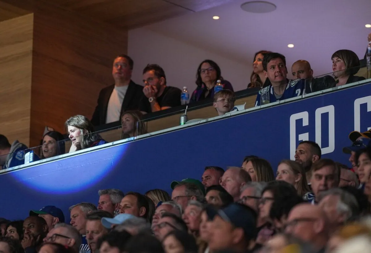 Alberta Premier Danielle Smith, front second left, and B.C. Premier David Eby, front second right, watch the Vancouver Canucks and Edmonton Oilers play Game 2 of an NHL hockey Stanley Cup second-round playoff series, in Vancouver, on May 10, 2024. (The Canadian Press/Darryl Dyck)