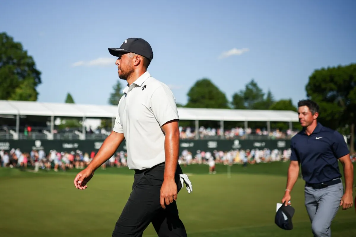 Xander Schauffele walks off the 18th hole green after finishing the third round of the Wells Fargo Championship at Quail Hollow Country Club in Charlotte on May 11, 2024. (Jared C. Tilton/Getty Images)