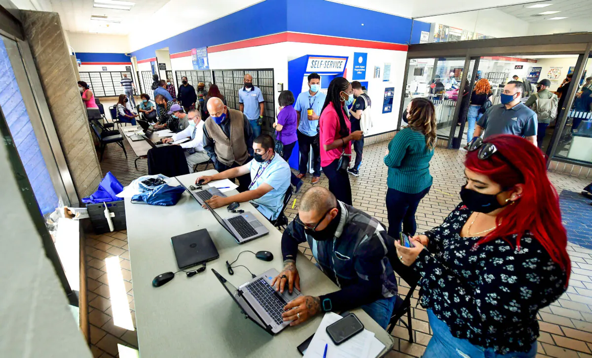 Applicants receive help with their applications during a job fair at a Post Office in Los Angeles on Sept. 30, 2021. (Frederic J. Brown/AFP via Getty Images)