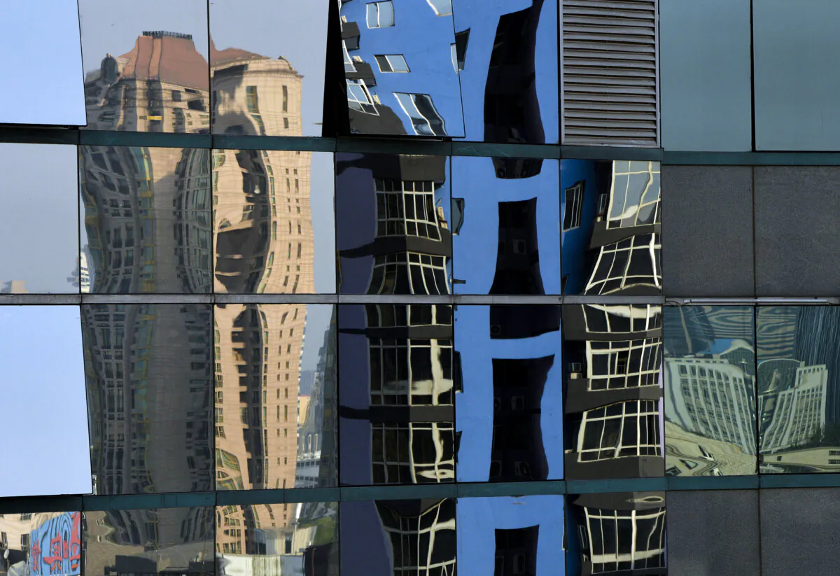 High rise properties are reflected on an office building's windows in Beijing on May 6, 2013. (Mark Ralston/AFP/Getty Images) 