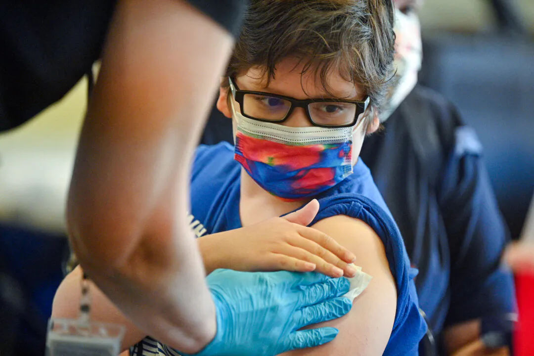 A boy receives a COVID-19 vaccine at a clinic at Los Angeles Mission College on Jan. 19, 2022. (Robyn Beck/AFP via Getty Images)