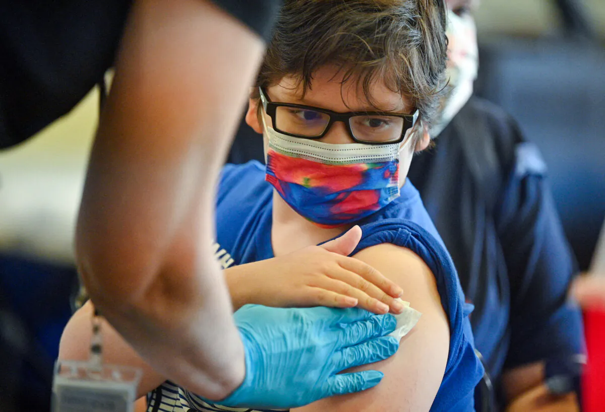 A boy receives a COVID-19 vaccine at a clinic at Los Angeles Mission College on Jan. 19, 2022. (Robyn Beck/AFP via Getty Images)