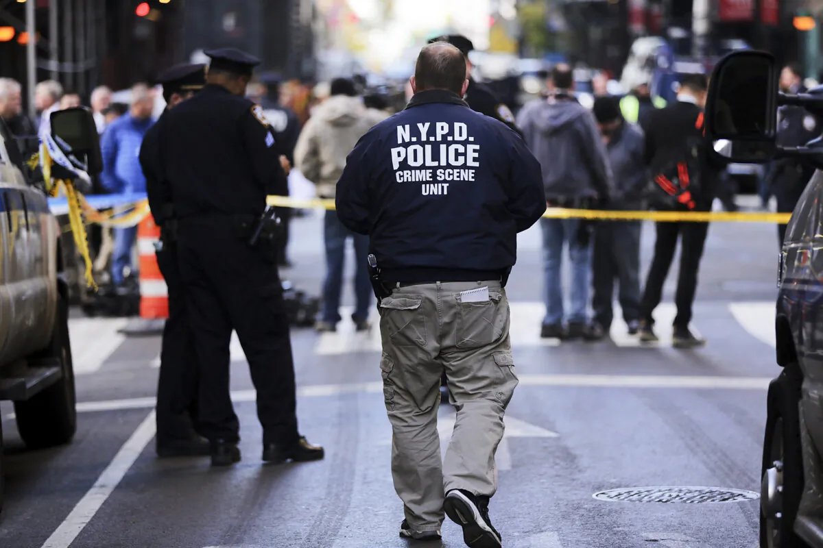 Police stand at the scene of a midtown shooting that left one dead with two others wounded on Nov. 9, 2015, in New York City. (Spencer Platt/Getty Images)