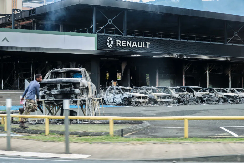 A view of burnt cars and a burnt Renault car shop amid protests linked to a debate on a constitutional bill aimed at enlarging the electorate for upcoming elections in the overseas French territory of New Caledonia, in Noumea, on May 14, 2024. (Theo Rouby/AFP via Getty Images)