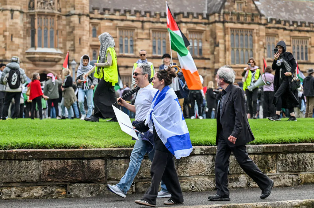 Members of the Australian Israeli community walk past members of the Australian Palestinian community at the Palestinian Protest Campsite at University of Sydney in Sydney on May 3, 2024. (Ayush Kumar/AFP via Getty Images)