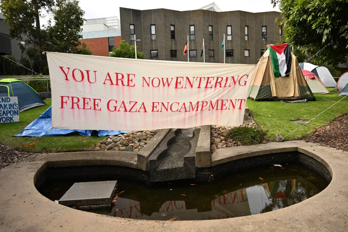 Signage and tents are seen at the pro-Palestine encampment at the Deakin University Burwood campus in Melbourne, Australia, on May 14, 2024. (AAP Image/James Ross)