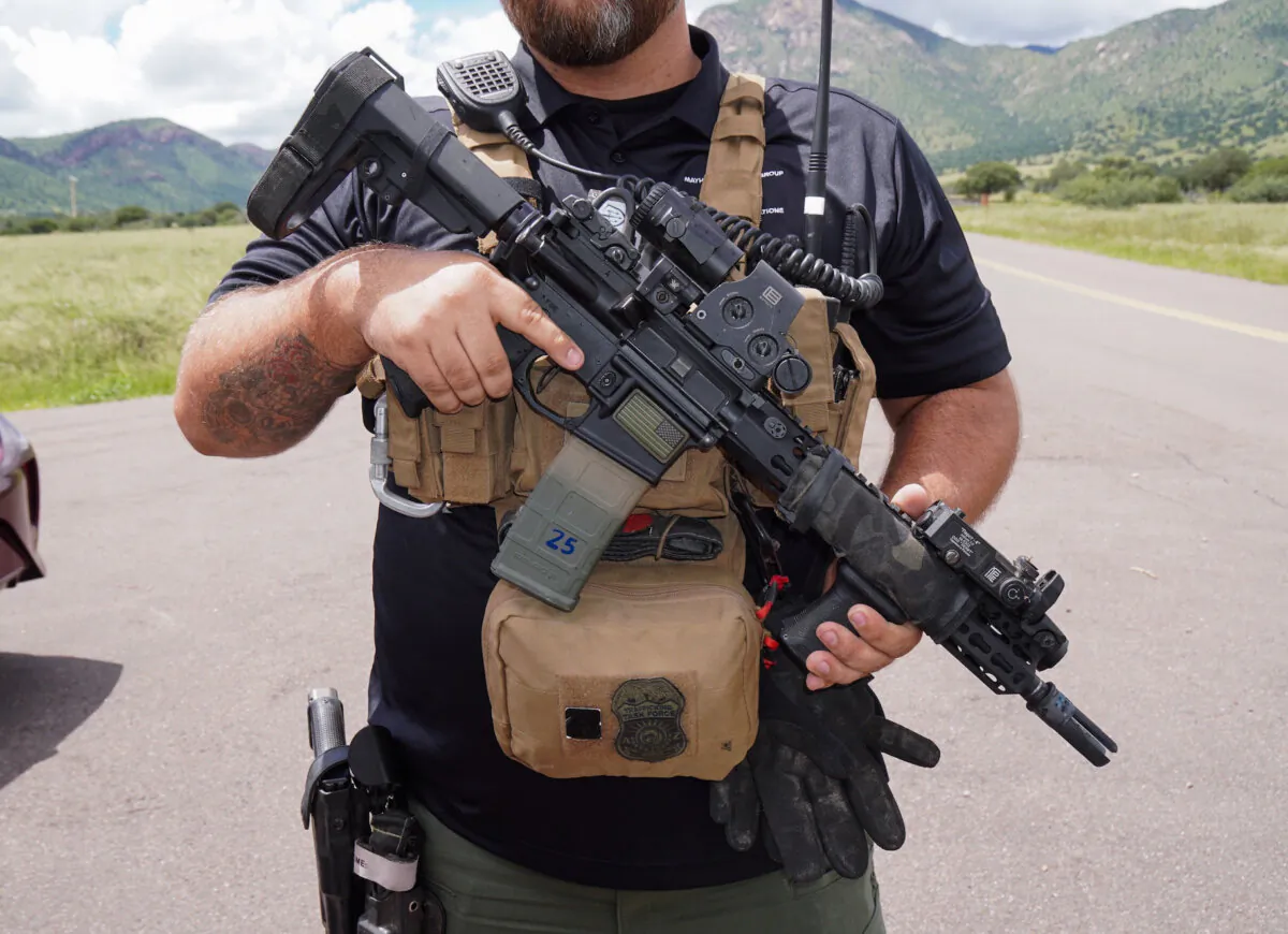 Kyle, a private security professional, carries an AR-15 semiautomatic rifle as personal protection before entering a known "hot spot" for human trafficking in the Coronado National Forest in southern Arizona. (Allan Stein/The Epoch Times)
