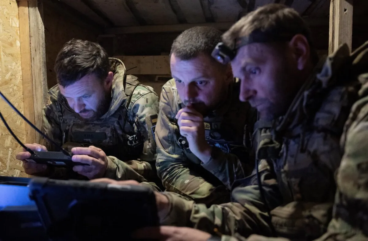 Soldiers from the 'Achilles' Battalion of the 92nd assault brigade of the Ukrainian Army control a Vampire hexacopter drone during a mission flight over a front line near Chasiv Yar, in the Donetsk region of Ukraine, on May 1, 2024. (Genya Savilov/AFP via Getty Images)
