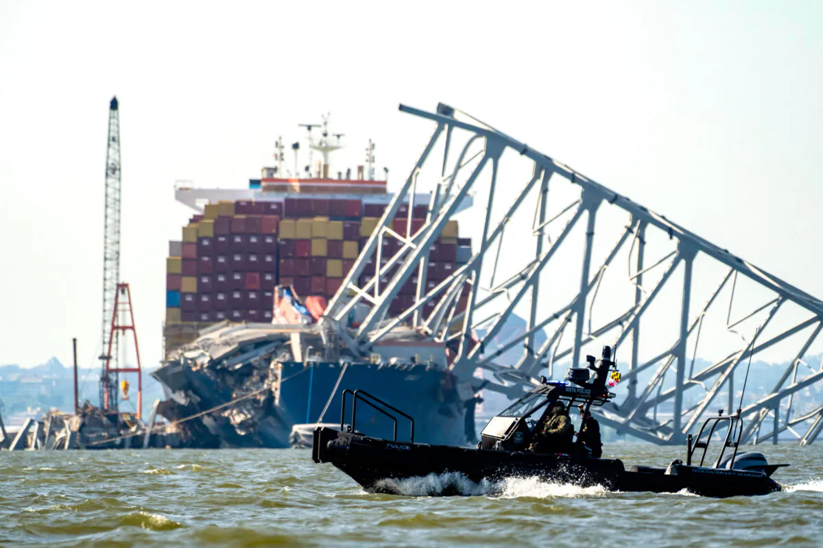 A Maryland Transportation Authority patrol boat makes a pass in the waters of the Patapco river near where crews were getting ready to conduct a controlled demolition of a section of the Francis Scott Key Bridge resting on the Dali container ship in Baltimore on May 13, 2024. (Roberto Schmidt/AFP via Getty Images)