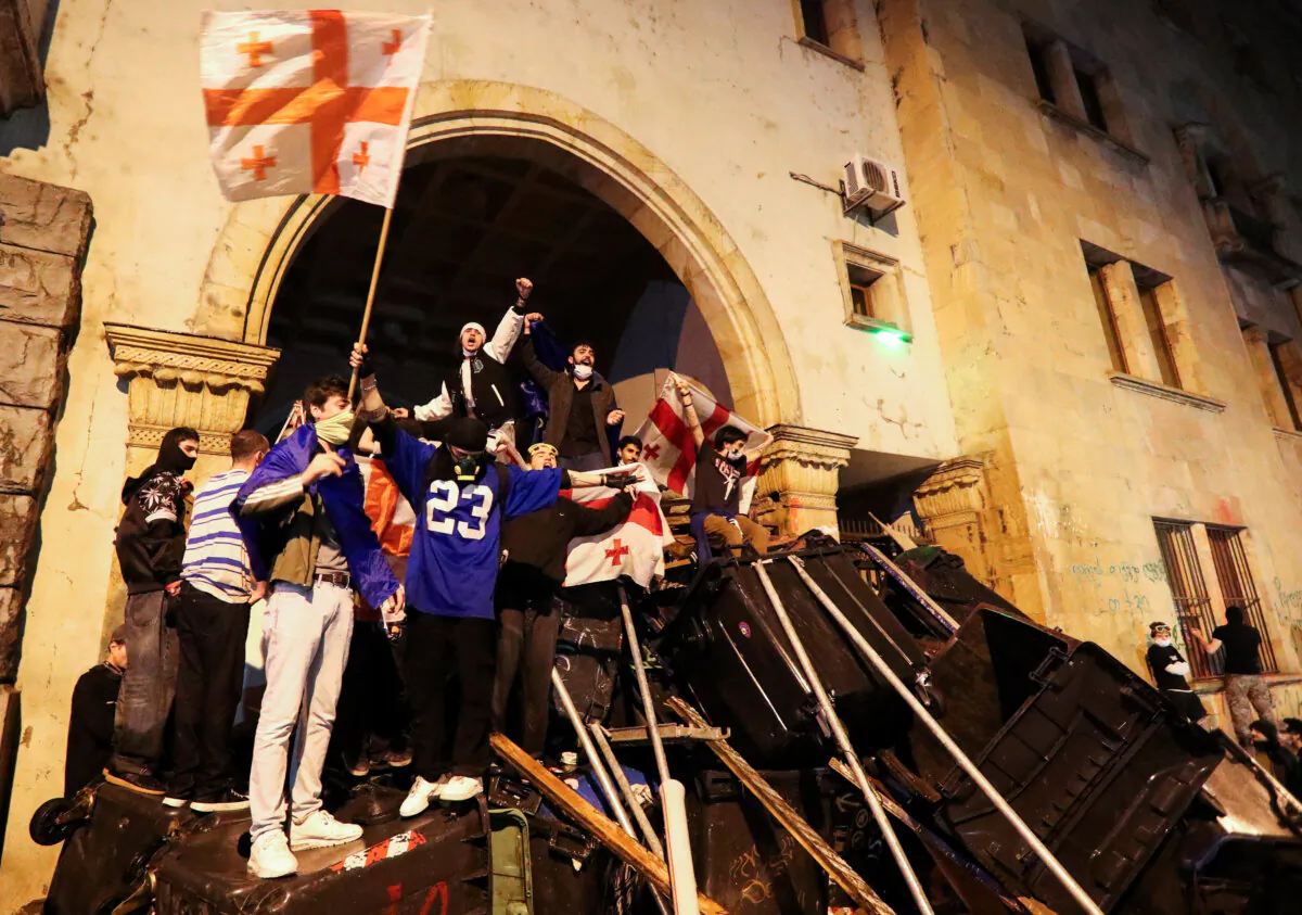Protesters barricade the entrance of the Parliament of Georgia during a rally to protest against a bill, in Tbilisi, Georgia, on May 2, 2024. (Irakli Gedenidze/Reuters)