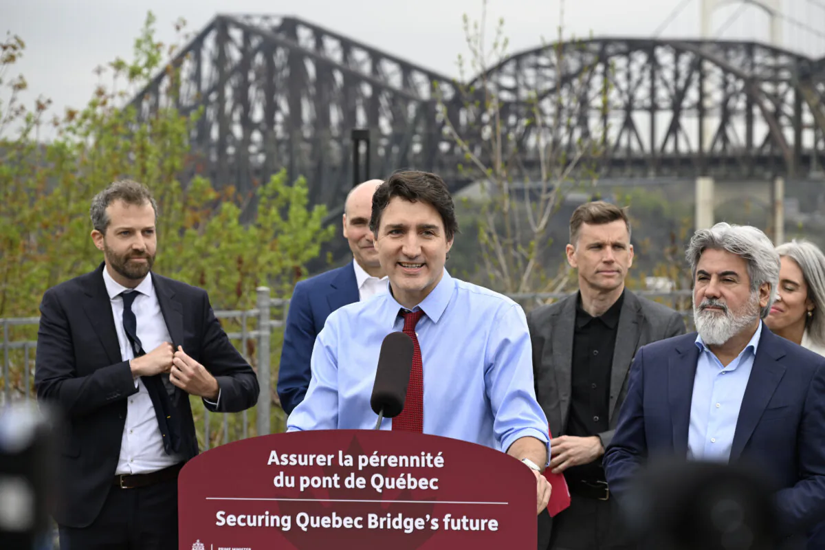 Prime Minister Justin Trudeau announces the purchase of the Quebec City bridge from Canadian National, May 15, 2024 in Quebec City. From left, MP Joel Lightbound, Jean-Yves Duclos, minister of Public Services and Procurement, Trudeau, Quebec City Mayor Bruno Marchand and Minister of Transport Pablo Rodriguez. (THE CANADIAN PRESS/Jacques Boissinot)