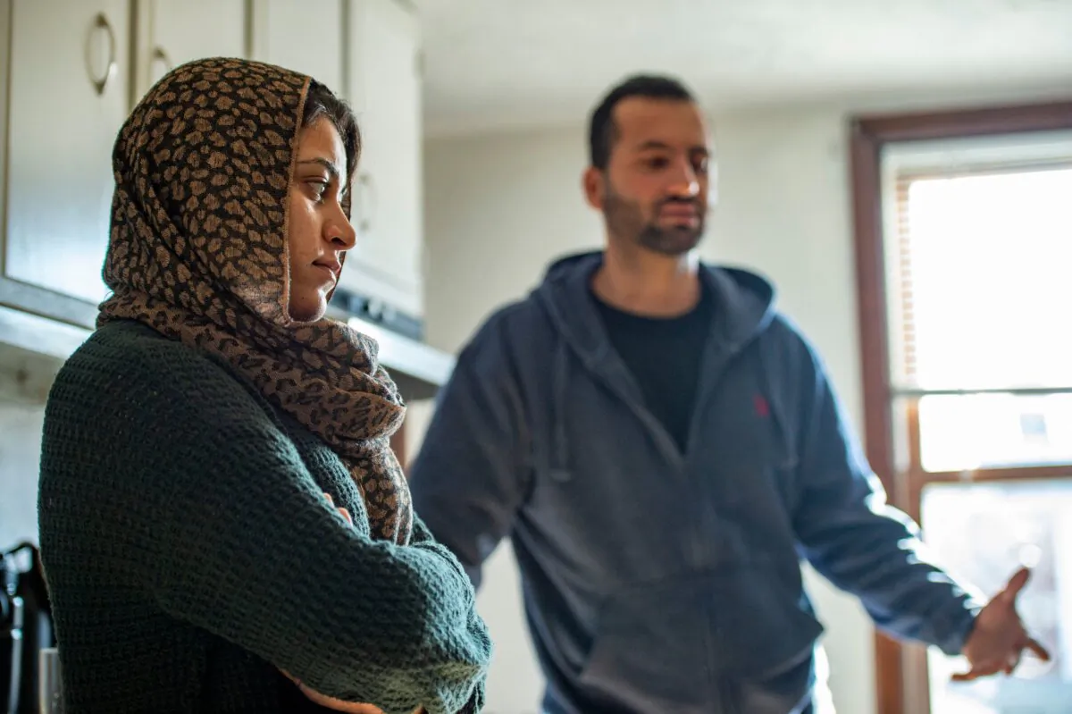 Afghani evacuees Israr and his wife Sayeda at their new apartment in Charlestown, Mass., on Feb. 21, 2022, after fleeing Afghanistan with thousands of other Afghanis evacuated after Kabul's fall to the Taliban. (Joseph Prezioso/AFP/Getty Images)