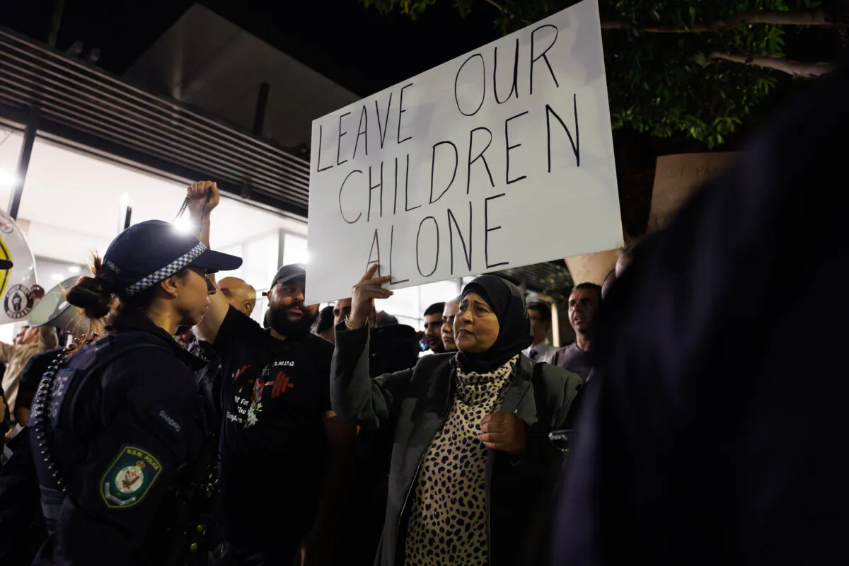 Protesters and counter-protesters gather outside the Cumberland City Council to voice their views on the bans on an LGBT book and drag story time in Sydney, Australia, on May 15, 2024. (AAP Image/Paul Braven)