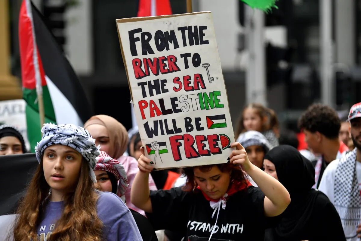 Protesters hold placards during a pro Palestine demonstration, in Sydney, Australia, on Dec. 7, 2023. (AAP Image/Bianca De Marchi)