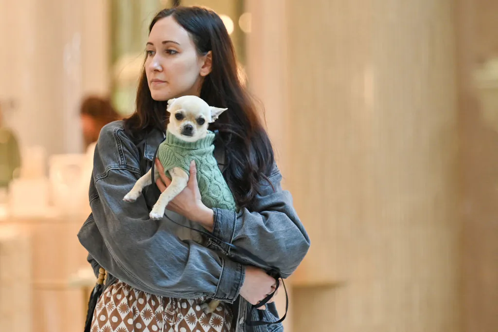 A woman carries a dog in Bondi Junction Westfield Shopping Centre in Sydney on April 19, 2024.(Photo by Ayush Kumar / AFP via Getty Images)