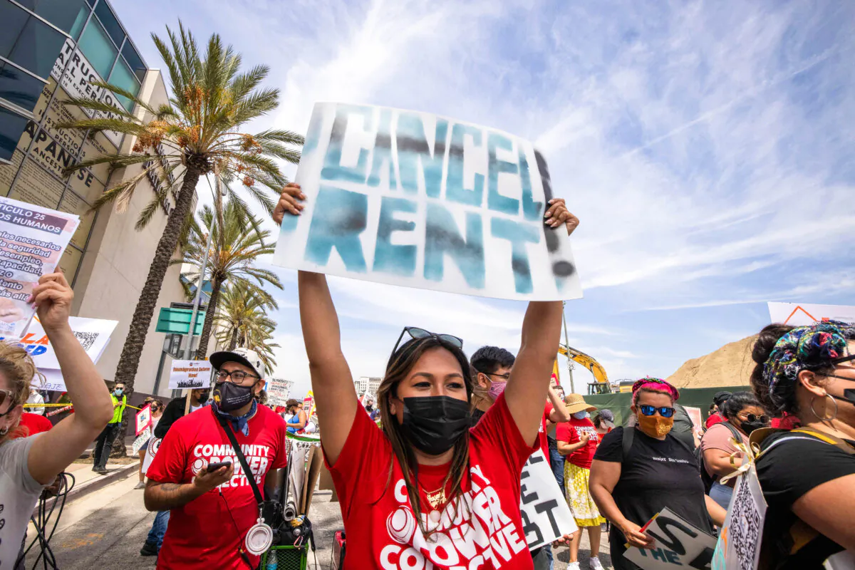 A woman calls for rent cancellation at a May Day march in Los Angeles on May 1, 2021. (David McNew/AFP via Getty Images)

