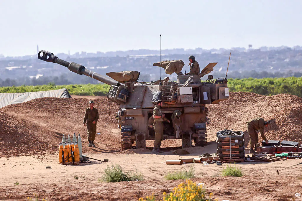 Israeli troops man a position with a mobile artillery unit near the border with the Gaza Strip on May 8, 2024. (Jack Guez/AFP via Getty Images)
