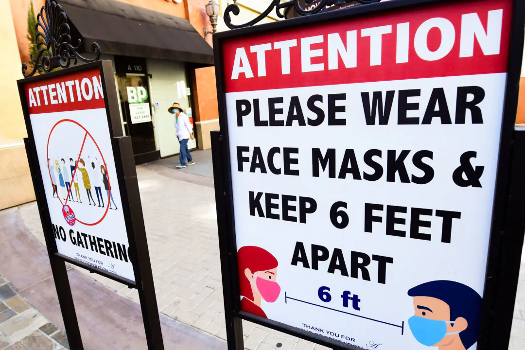 Signs reminding people of social distancing and wearing face masks remain at a mall in California June 14, 2021. (Frederic J. Brown/AFP via Getty Images)