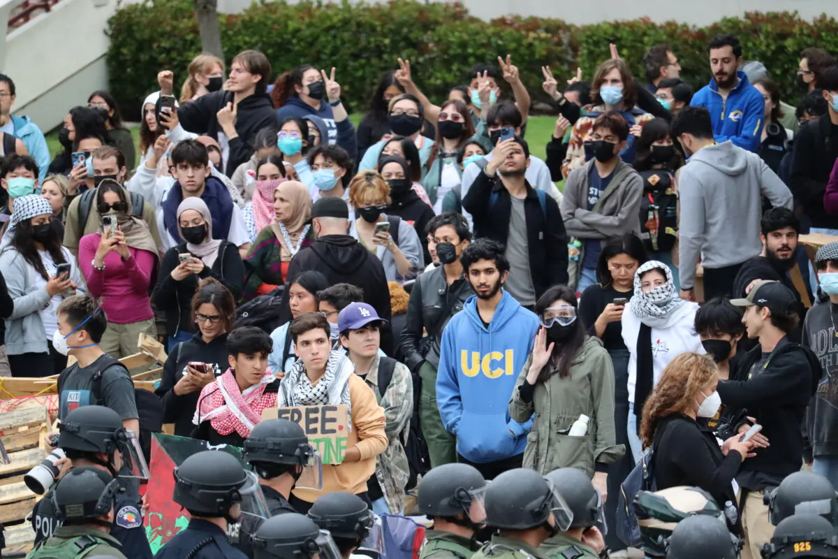 Police face off with pro-Palestinian students and activists during a protest at the University of California–Irvine in Irvine, Calif., on May 15, 2024. (May He/The Epoch Times)