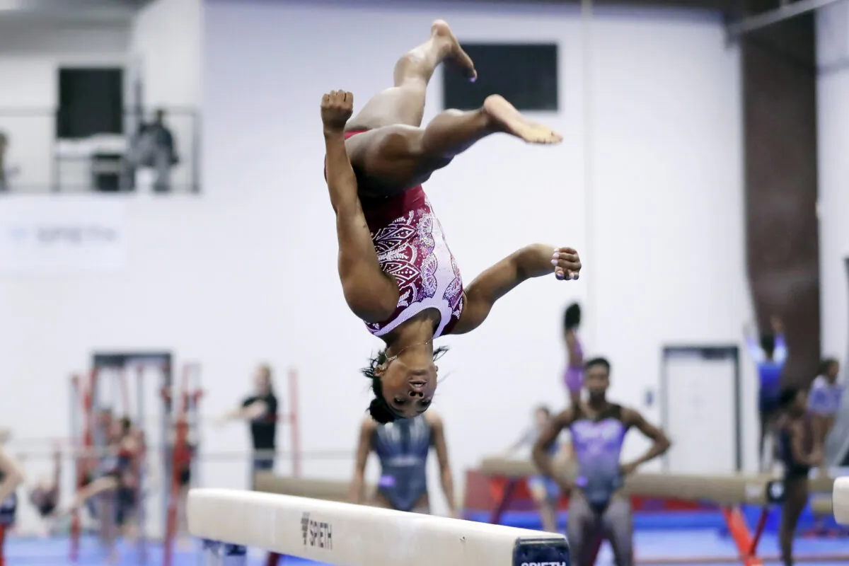 Simone Biles works on the balance beam in Katy, Texas, on Feb. 5, 2024. (Michael Wyke/AP Photo)