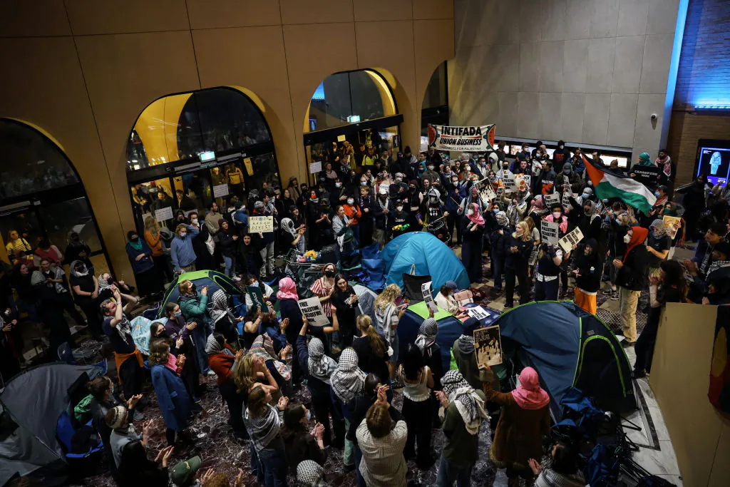 Pro-Palestinian students hold a sit-in in Melbourne on May 15, 2024 at Melbourne University's Arts West building, which the students have temporarily renamed as "Mahmoud's Hall" after Mahmoud Al Haq, a prospective University of Melbourne student, who died in Gaza. (Photo by Martin KEEP / AFP) (Photo by MARTIN KEEP/AFP via Getty Images)