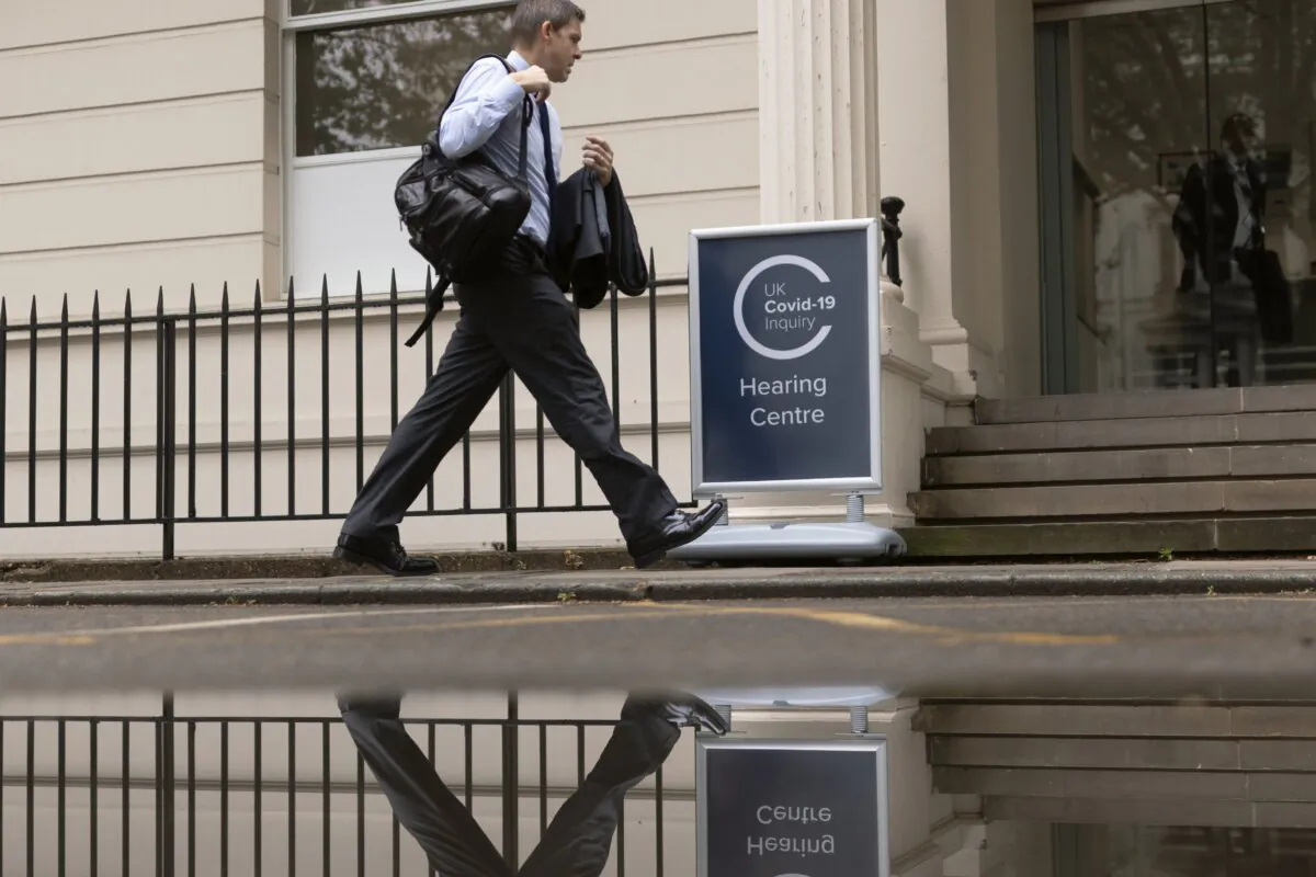 A member of the public walks past the venue to the UK COVID-19 Inquiry in London on June 20, 2023. (Dan Kitwood/Getty Images)