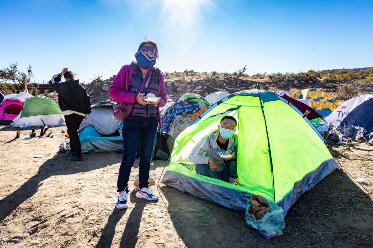 Chinese migrants settle at Willow Camp before being processed by Border Patrol agents in Jacumba, Calif., on Dec. 6, 2023. (John Fredricks/The Epoch Times)