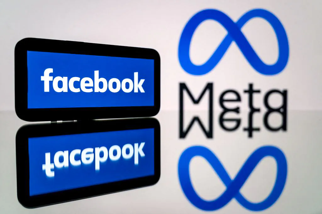 A smartphone and a computer screen displaying the logos of the social network Facebook and its parent company Meta, in this file photo. (Lionel Bonaventure/AFP via Getty Images)