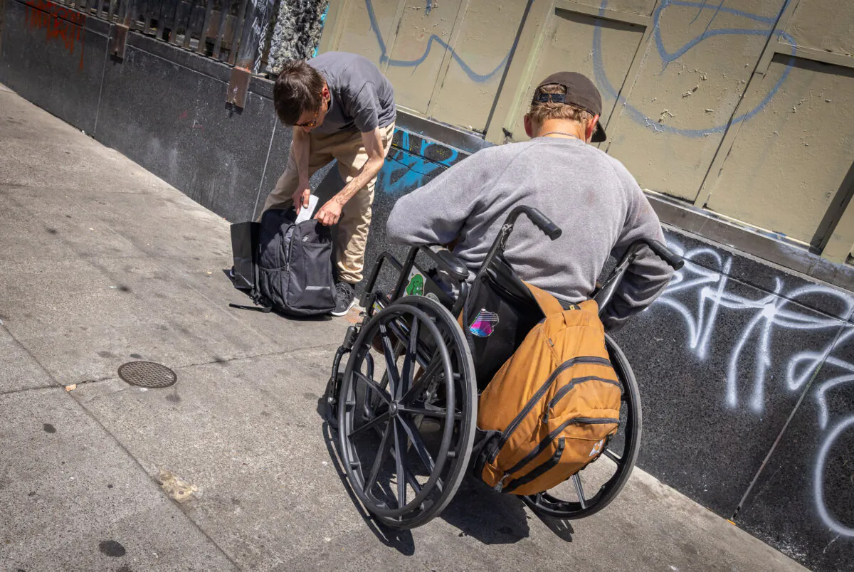 People hold drugs in the Tenderloin District of San Francisco on May 16, 2024. (John Fredricks/The Epoch Times)