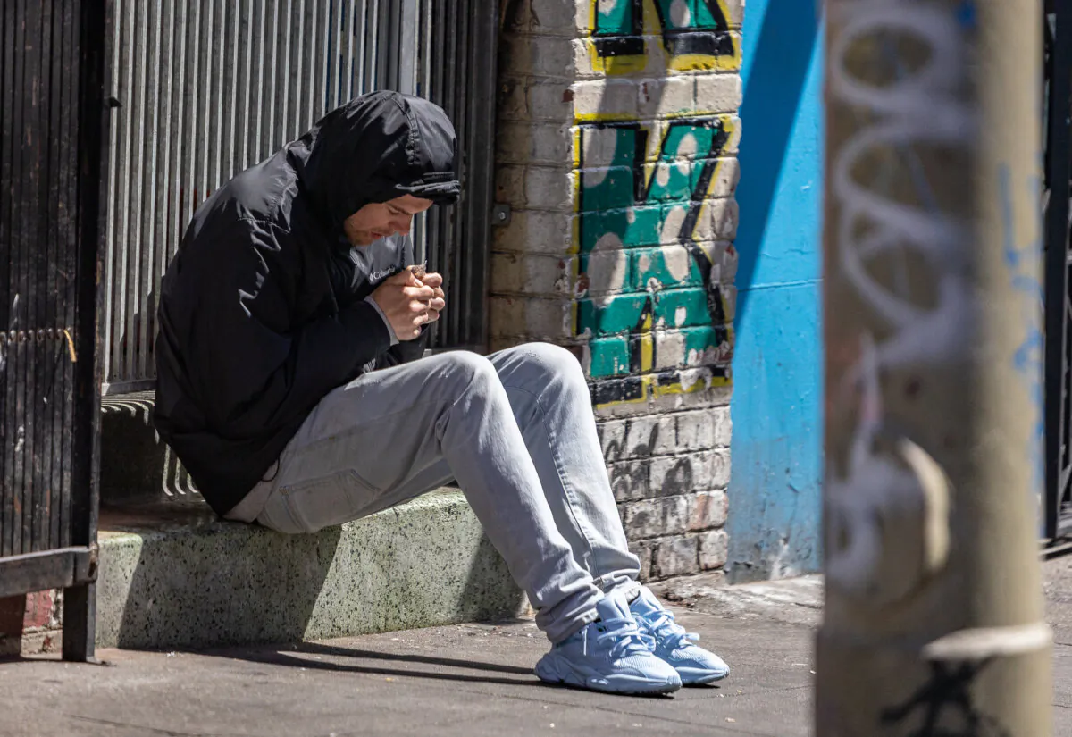 A drug user sits in the Tenderloin District of San Francisco on May 16, 2024. (John Fredricks/The Epoch Times)
