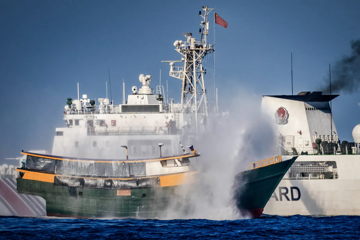 A Chinese Coast Guard ship fires a water cannon at a Philippine Navy chartered vessel conducting a routine resupply mission to troops stationed at Second Thomas Shoal, in the South China Sea on March 5, 2024. (Ezra Acayan/Getty Images)