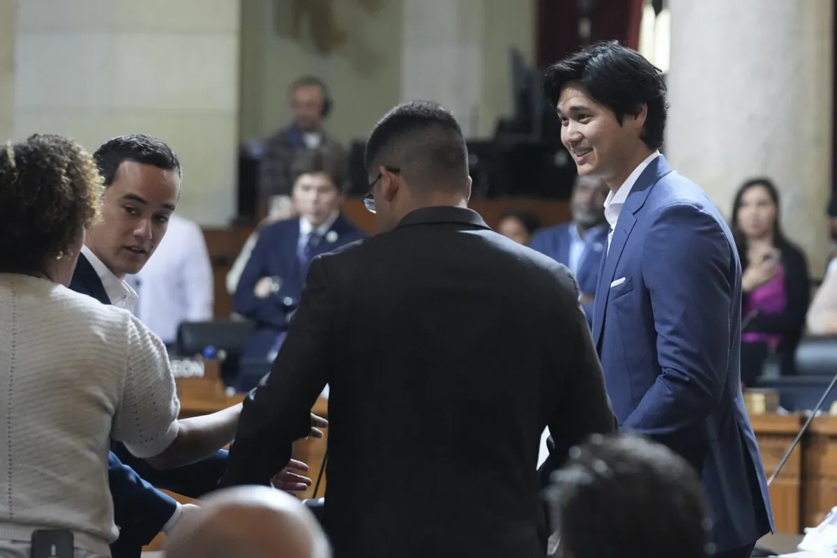 Los Angeles Dodgers baseball star Shohei Ohtani (R) is honored during a council meeting in Los Angeles on May 17, 2024. (Damian Dovarganes/AP Photo)