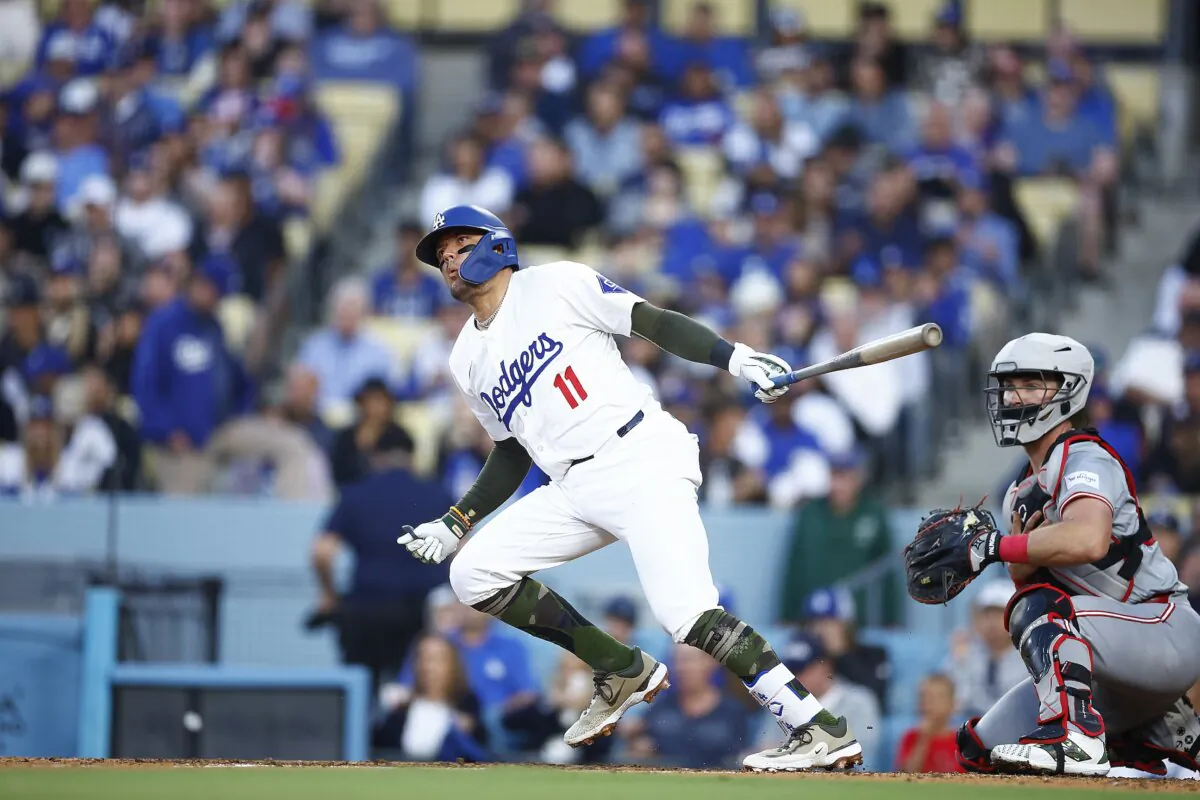 Miguel Rojas (11) of the Los Angeles Dodgers hits a double against the Cincinnati Reds in the fifth inning in Los Angeles on May 18, 2024. (Ronald Martinez/Getty Images)