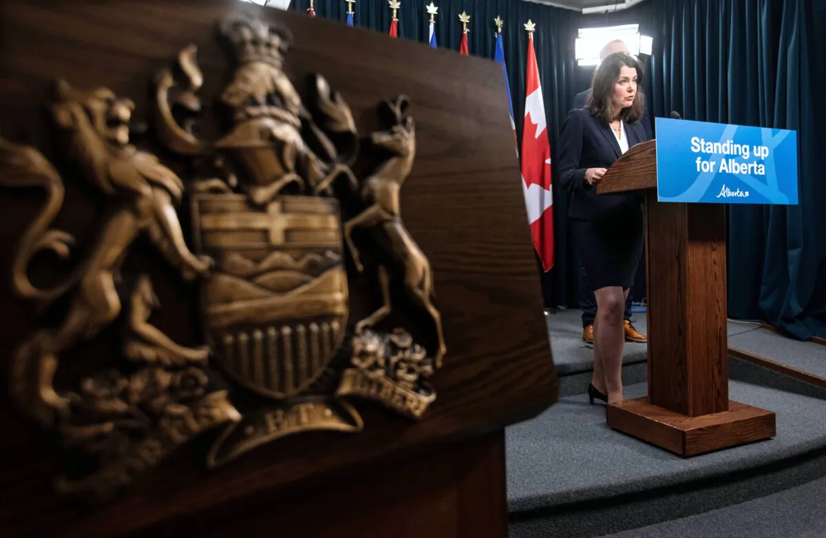 Premier Danielle Smith speaks about invoking Alberta’s Sovereignty Act over federal clean energy regulations, in Edmonton on Nov. 27, 2023. The province’s coat of arms, Fortis et Liber, is seen on the left. (The Canadian Press/Jason Franson)
